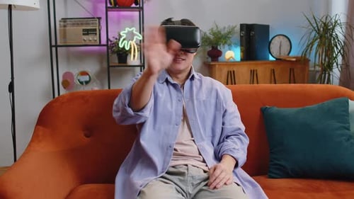 Man Using Virtual Reality Headset on Sofa
