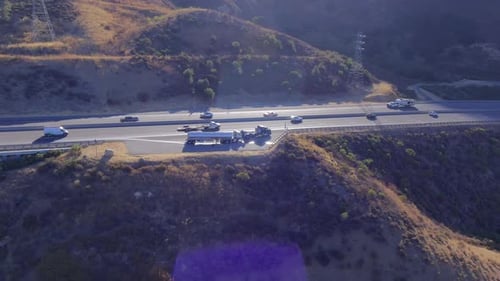 Aerial orbit view of truck roadside assistance next to busy highway
