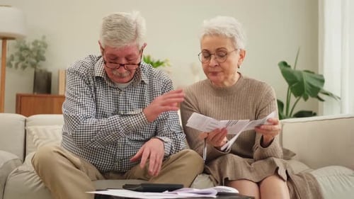Senior Couple Working on Bills at Home Together