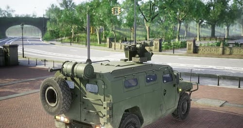 Military Vehicle Parked at a City Corner Surrounded By Greenery in Daylight