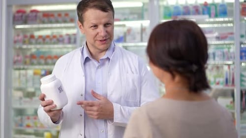 Smiling Pharmacist Explains Medication to Customer