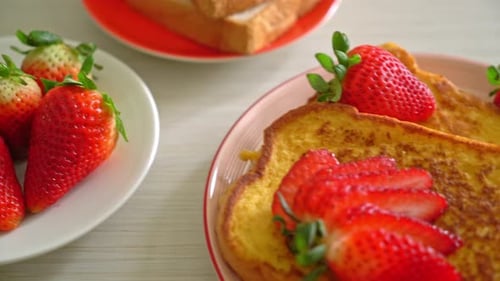 french toast with fresh strawberry on plate