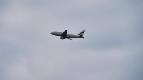 Commercial Airplane Flying Through the Overcast Sky
