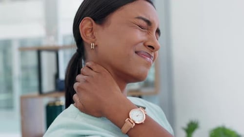 Woman Rubbing Stiff Neck in Office Environment