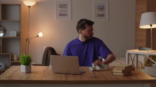Man Works at Laptop in Cozy Home Setting