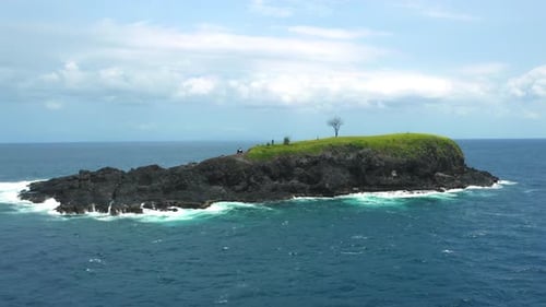 Aerial Tracking Shot Of A Beautiful Island Isolated In Blue Ocean Landscape