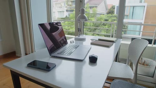 Desk of Office Employee with Wireless Laptop