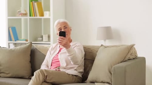 Senior Woman Taking Selfie on Couch at Home