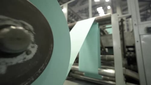 Large Cylindrical Objects Wind Paper in Work Area of Plant