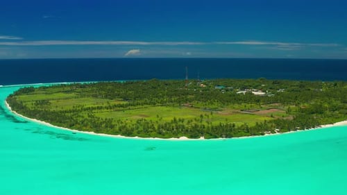 Aerial view on Thoddoo island with turquoise ocean, green palm trees and blue sky on Maldives