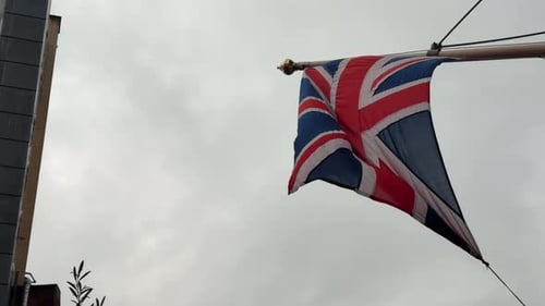 British Flag Waving in the Wind on Overcast Day
