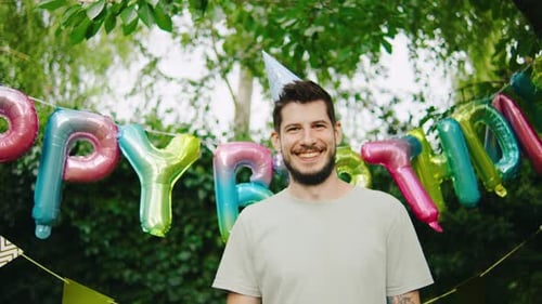 Man Celebrates Birthday in Sunny Backyard Setting