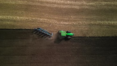 Tractors plowing the field in Ukraine