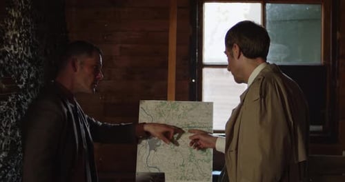 Men Plan Next to Map Inside Room
