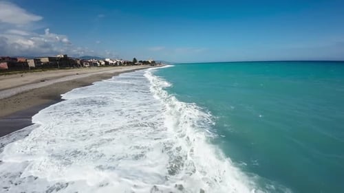 Ocean Waves Crashing Into Sandy Beach