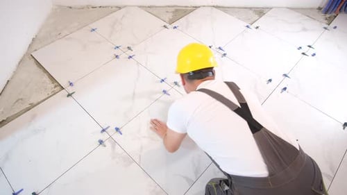 Man Installing Tile in Home Renovation Project