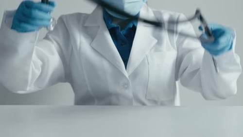 Medical Professional with Stethoscope and Blue Gloves