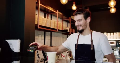 Smiling Barista Serving Coffee at Cafe Counter