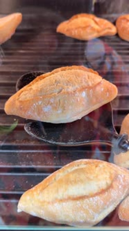 Loaves of Bread are Carefully Toasted Over Flame