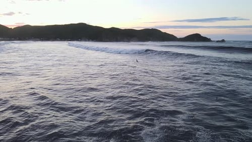 Raging Sea in the Morning at Dawn Waves Roll on the Rocky Shore Spray Soars Into the Sky