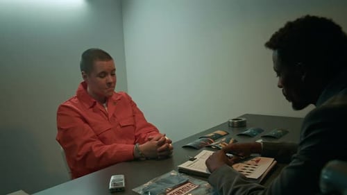 Police Interrogation of Person in Orange Jumpsuit