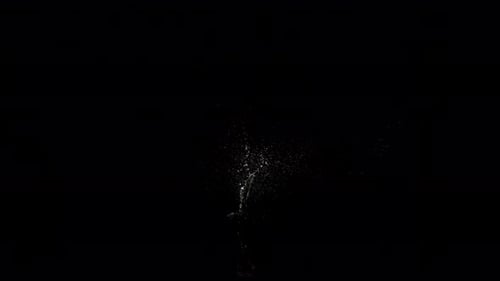 Abyss Collection: A small splash above the surface of water over a black background