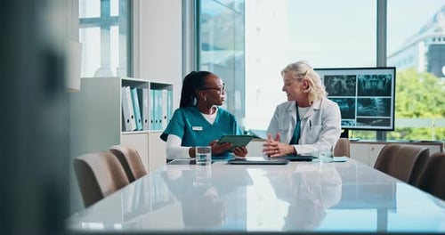 Doctors Discussing Patient Treatment Plan in Meeting