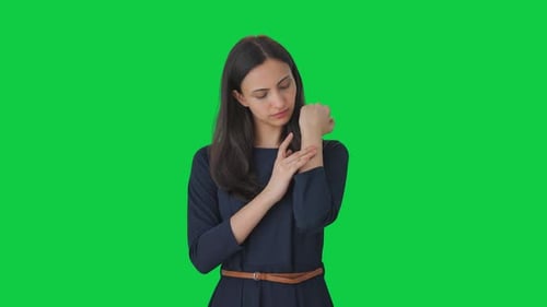 Indian girl putting a bandage on arm Green screen