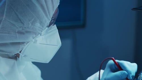 Microelectronics Engineer Works in a Modern Scientific Laboratory on Computing Systems and