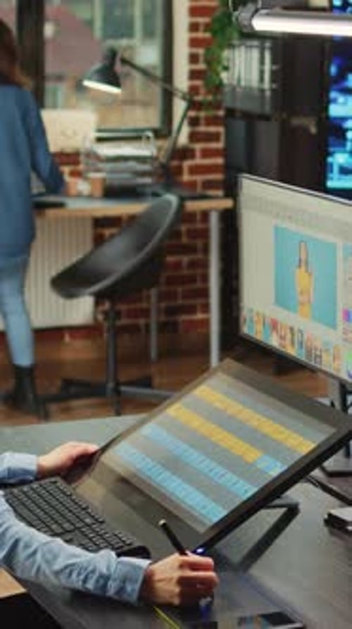 Women Collaborating on Photo Retouching in Office