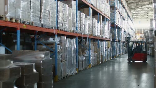 Forklift Loader is Moving Cargo Goods in Logistic Warehouse