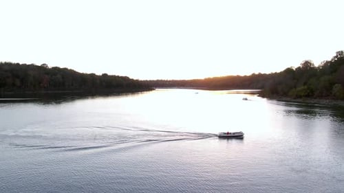 Dolly Forward over a Boat on a Lake Towards the Sunset