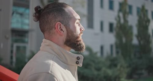 Handsome Bearded Man Looks Upward in the City