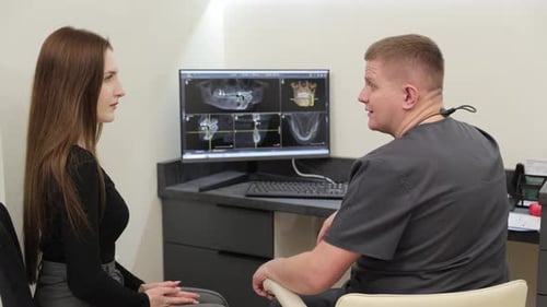 Doctor Explains X-Ray to Young Adult Patient
