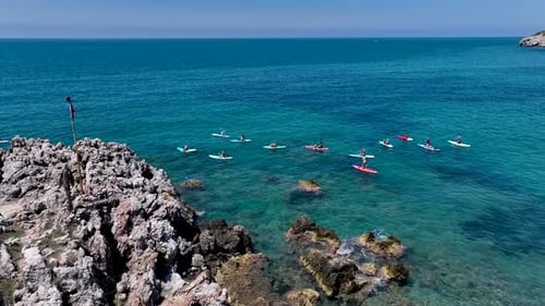 Aerial View Group Paddleboarding and Enjoying a Summer Festival in a Bay