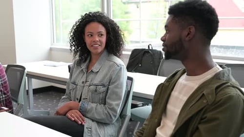 Young adults talking in office meeting space