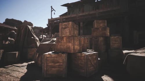 Wood Crates Stacked Outside a Weathered Building in a Desert Town at Dusk