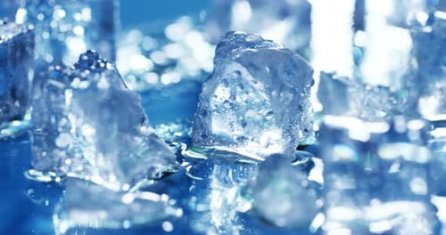 Macro shot of pure water ice cubes that melt in slow motion on a blue background. Concept: pure mo