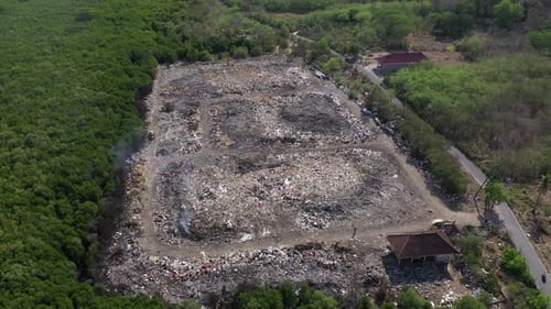Rubbish tip, landfill, waste area in Lembongan Bali drone pull back shot