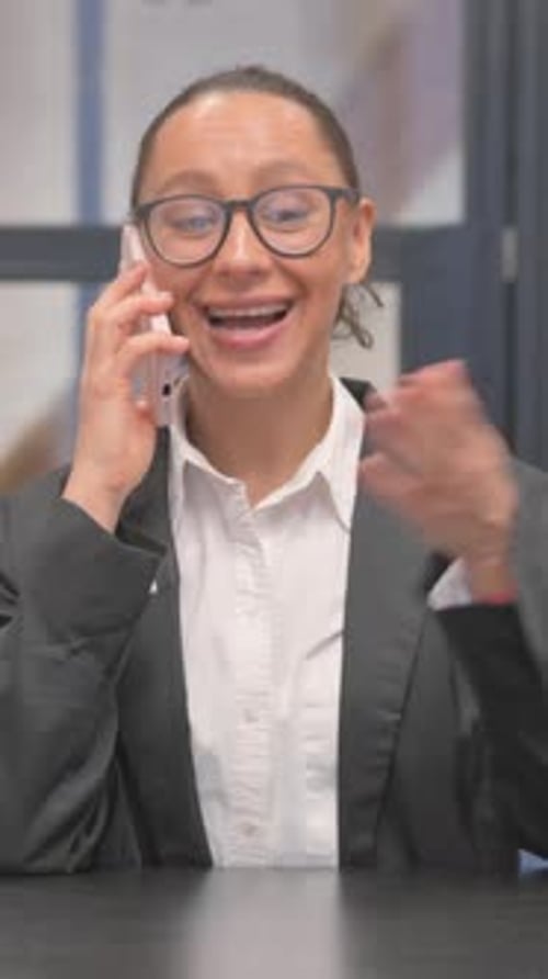 Mixed Race Business Woman Talking on Phone in Office, vertical video