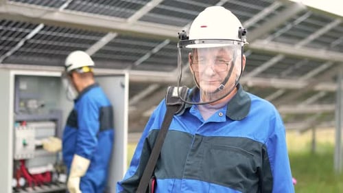 Mature Service Engineer Man Standing in Front of Solar Panels Technician Maintenance Solar Cells on