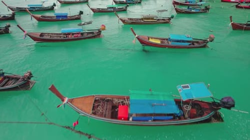 Aerial view of anchored fishermen boats in turquoise waters, Thailand.