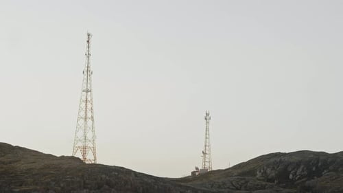 A Pair of Tall Radio Towers Provide Cellular Communication in the Northern Region Situated on a Hill