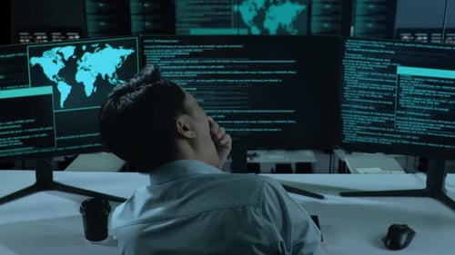 Tired Asian Man Yawning Before Sleeping While Write Code With Multiple Computer Screens In office