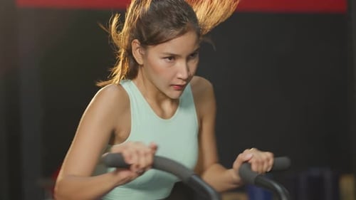 Asian young beautiful sportswoman athlete exercise in fitness stadium.