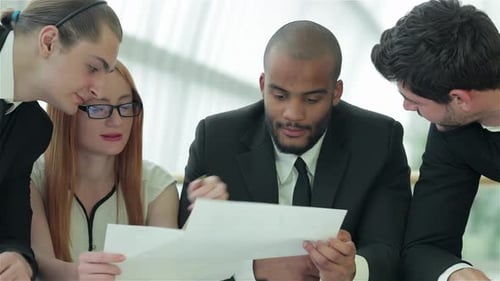 Businessmen Sitting at Table in Office While Discussing Their of Business Doings