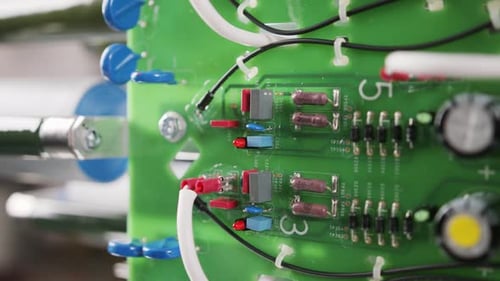 Electronic components and capacitors inside an electronic device. Close up tracking shot.