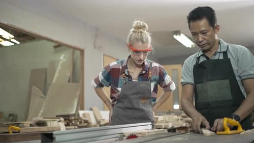 Carpenters are working together at workshop.