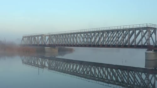 Railway Bridge Over the River in the Fog in the Morning