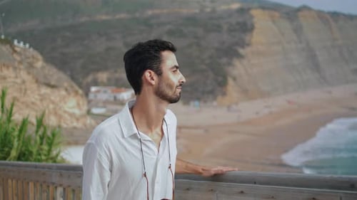 Peaceful Guy Enjoying Sea Horizon Closeup. Calm Person Walking Stairs Watching Sunny
